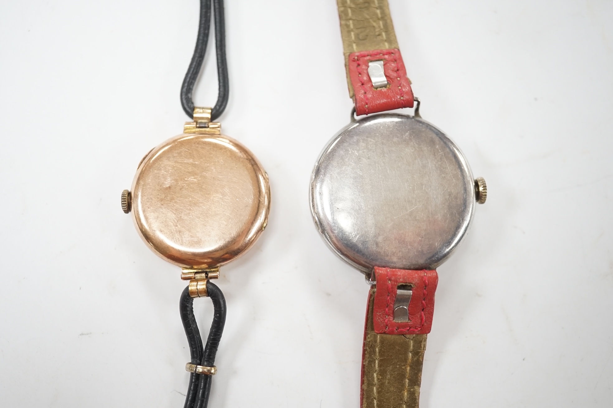 A George V 9ct gold manual wind wrist watch, with Roman dial, case diameter 27mm and a similar silver manual wind wrist watch. Condition - poor to fair